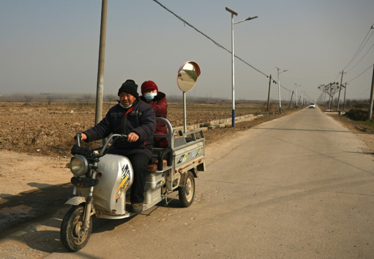 A man drives a tricycle along a street in Fengyang County in east China's Anhui Province