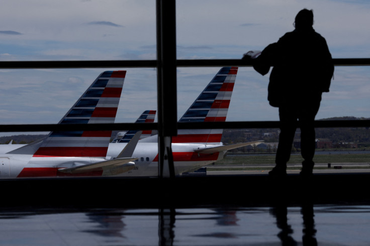 American Airlines aircraft are seen while a passenger waits for boarding at the Reagan International Airport in Washington