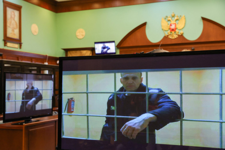 Jailed Russian opposition leader Alexei Navalny is seen on screens during a court hearing in Moscow