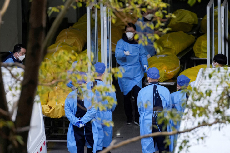 A staff member walks next to bodies in body bags at a funeral home, as coronavirus disease (COVID-19) outbreaks continue in Shanghai