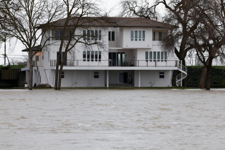 The rain-swollen Sacramento River rises to the foundation level of homes along the river in West Sacramento