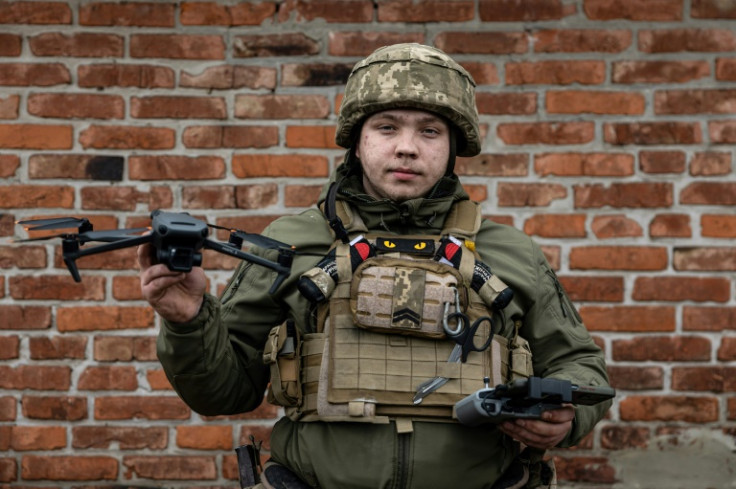 A Ukrainian serviceman poses with a drone on the outskirts of Bakhmut in December 2022