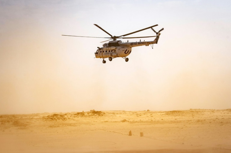 A UN helicopter lands on the Moroccan side of the border crossing between Morocco and Mauritania at Guerguerat in the Western Sahara, on November 25, 2020