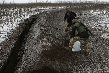 Ukrainian soldiers equip trenches on a field not far from Soledar in Donetsk, a town Russian forces said they had recently captured
