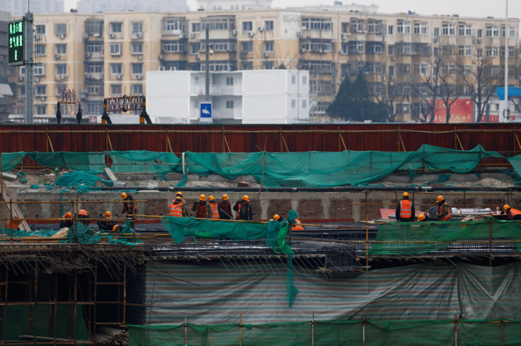 Workers work at a construction site in Beijing