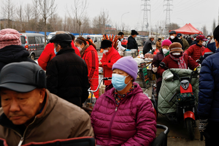 People shop at a market in Beijing