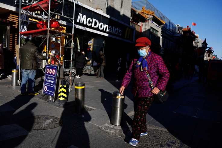A person walks past Qianmen street ahead of the Chinese Lunar New Year in Beijing