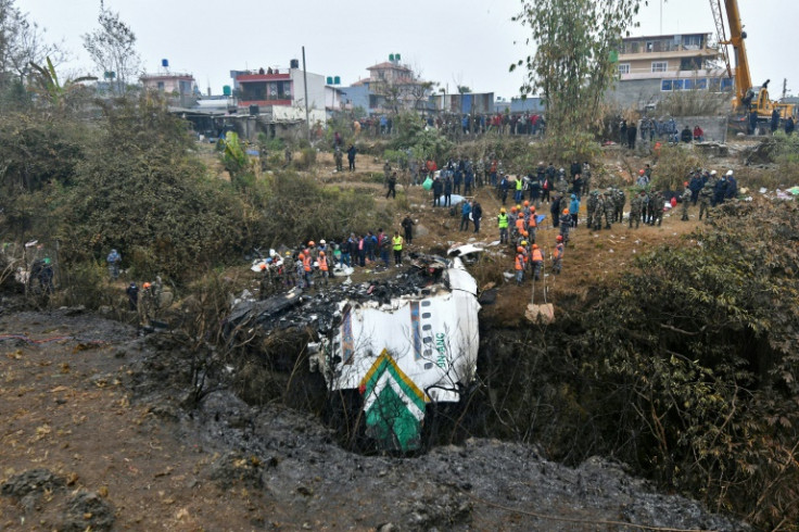 Rescuers search the wreckage of a Yeti Airlines plane crash but there was little hope of finding any survivors among the 72 people on board