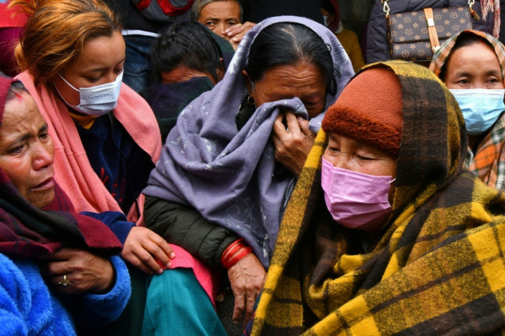 Grieving relatives wait for news of family members on board a Yeti Airlines plane that crashed in Nepal. There was little hope of finding any survivors among the 72 people on board
