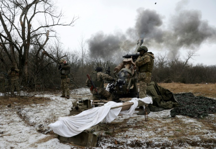 Ukrainian artillerymen fire a howitzer towards Russian positions at a frontline in the Lugansk region on January 16, 2023, amid the Russian invasion of Ukraine