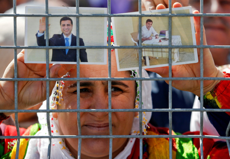 A woman holds pictures of jailed former leader of Turkey's main pro-Kurdish Peoples' Democratic Party Selahattin Demirtas as people gather to celebrate Newroz, which marks the arrival of spring and the new year, in Istanbul