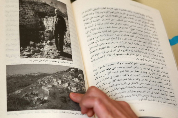 Darin J. Sallam points to a historic picture of houses in Mandatory Palestine, as she talks about her film "Farha"