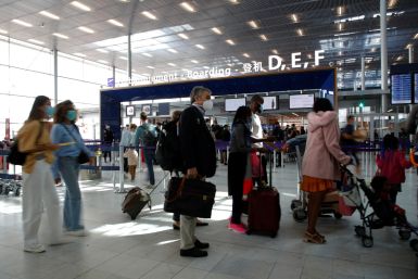 Passengers stand in a queue at Orly Airport