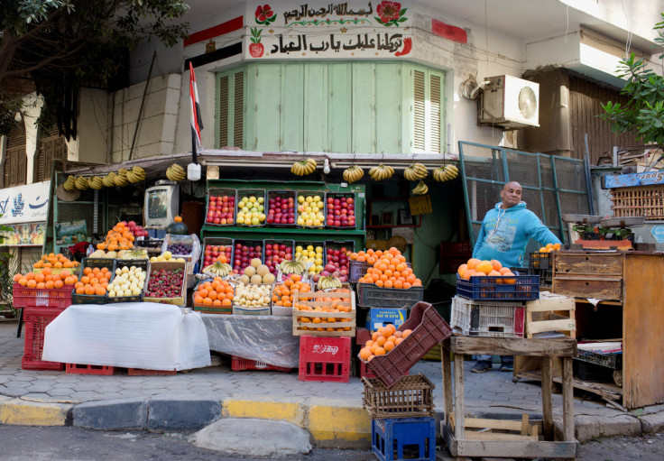 Egyptian vegetable and fruit seller waits for customers at a popular market in Cairo