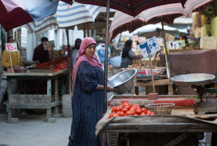 Egyptian vegetable sellers wait for customers at a popular market in Cairo