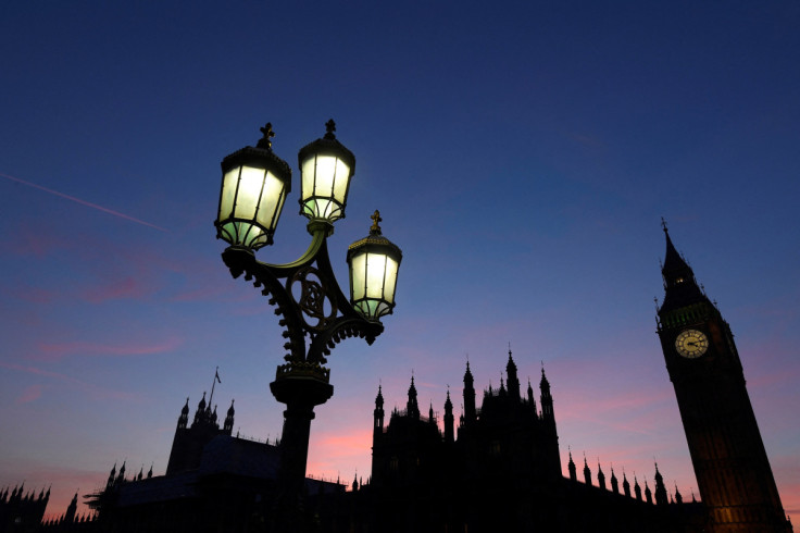 Dusk falls behind the Houses of Parliament on a clear evening in Westminster, central London