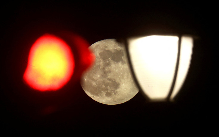The supermoon is seen behind street lights in Frankfurt