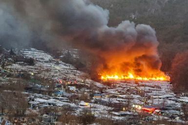 Smoke rises from a fire at Guryong village in Seoul