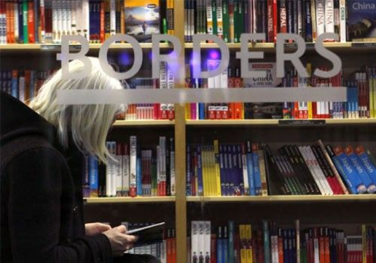 A customer is seen through the window of a Borders book store in New York
