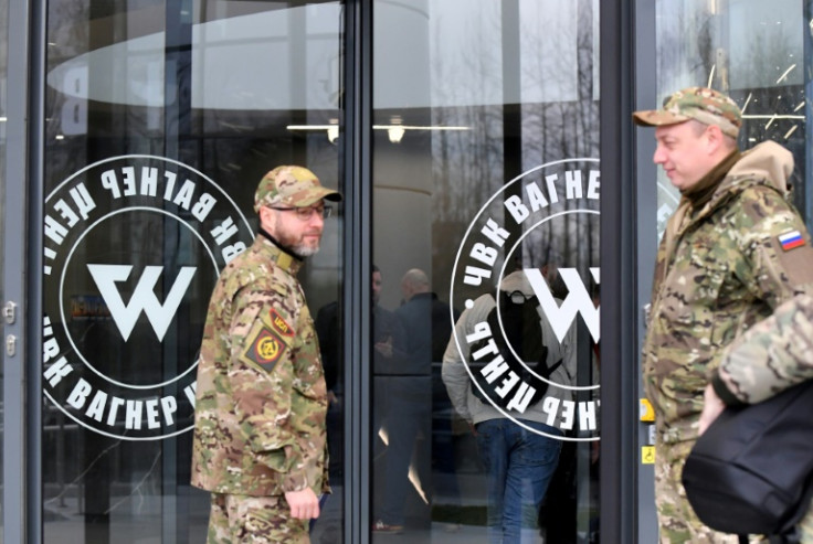 Visitors in military camouflage at the entrance of the new 'PMC Wagner Centre', recently opened in St. Petersburg by Yevgeny Prigozhin, the owner of the Wagner Private Military Company