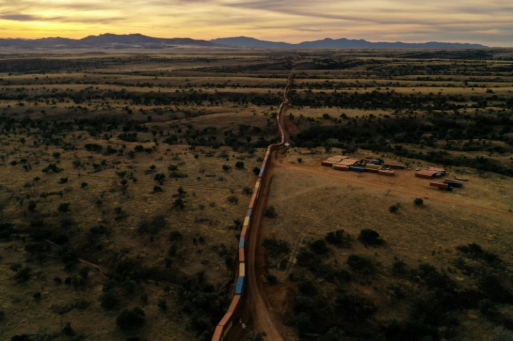 From the air, the makeshift wall of shipping containers along the US-Mexico border in Arizona resembles an enormous stationary freight train