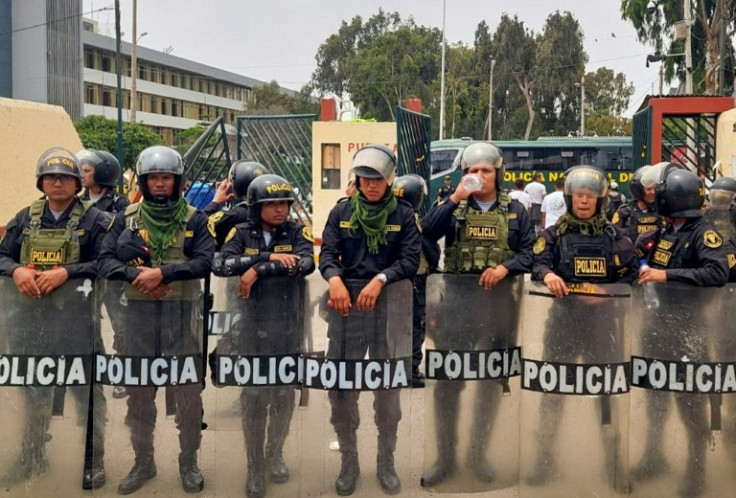 Riot police enter the University of San Marcos campus in Lima on January 21, 2023