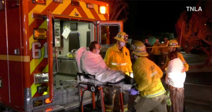 Screenshot from a video shows emergency responders assisting a person to an ambulance following a shooting at Monterey Park