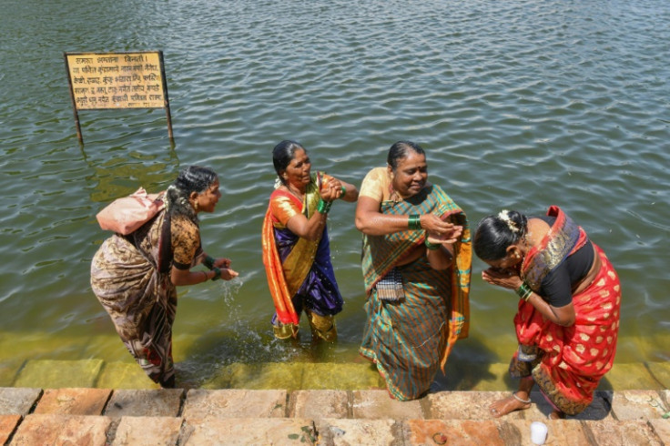 Huvakka Bhimappa, along with other former 'devadasis' women who were dedicated by their families to the Hindu Goddess Yellamma Devi, cleanse themselves in a pond