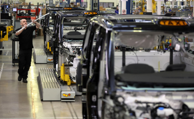 A worker walks along the TX electric taxi production line inside the LEVC (London Electric Vehicle Company) factory in Coventry