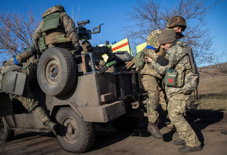 Ukrainian military paramedic attends Ukrainian serviceman who was wounded during shelling at the frontline near Bakhmut