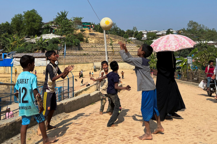 Rohingya children play with a football inside a refugee camp in Cox's Bazar