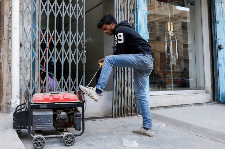 A man starts a generator outside his shop during a country-wide power breakdown in Karachi