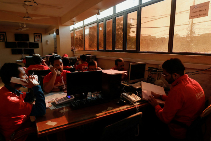 Volunteers of the Edhi Foundation, work at a communication and control room during a country-wide power breakdown in Karachi