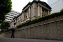 A man walks past Bank of Japan's headquarters in Tokyo