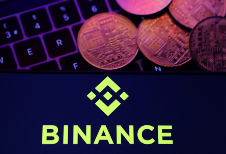 Illustration shows Binance logo and representation of cryptocurrencies