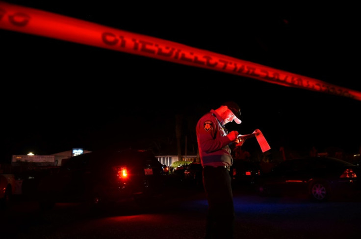 A San Mateo County sheriff deputy stands at the scene of a shooting in Half Moon Bay, California on January 23, 2023