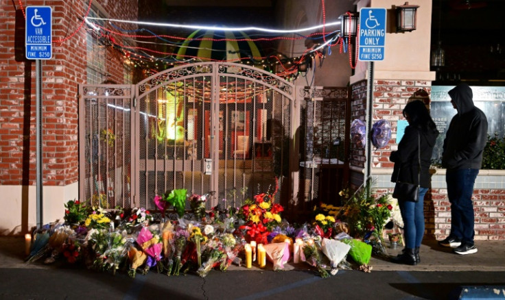 People pay their respects in front of a makeshift memorial for victims of a mass shooting outside the Star Dance Studio in Monterey Park, California on January 23, 2023