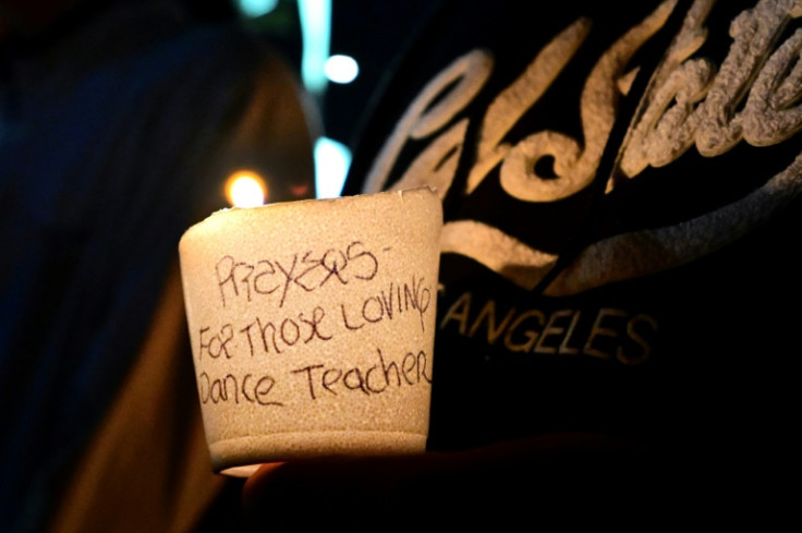 People attend a candle light vigil for victims of a mass shooting outside the City Hall in Monterey Park, California on January 23, 2023