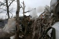 A Ukrainian serviceman fires an RPG towards a Russian position in Donetsk