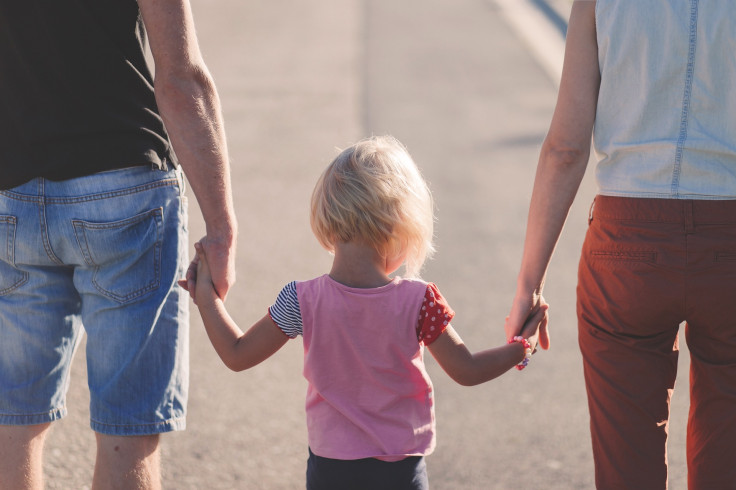 family holding hands parents child