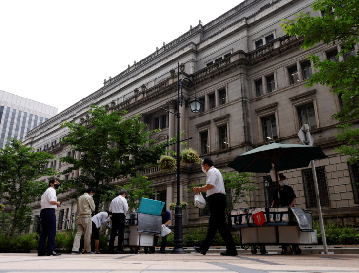 People buy their lunches from street vendors in front of the headquarters of Bank of Japan in Tokyo