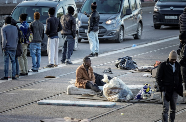 Migrants camp out on the pavement outside a Casablanca bus station, killing time as dreams of reaching Europe are on hold