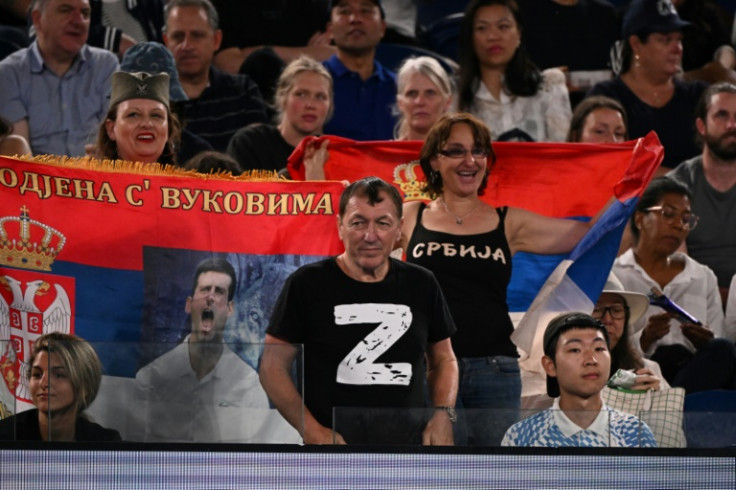 A man wearing a "Z" T-shirt watches the quarter-final between Serbia's Novak Djokovic and Russia's Andrey Rublev