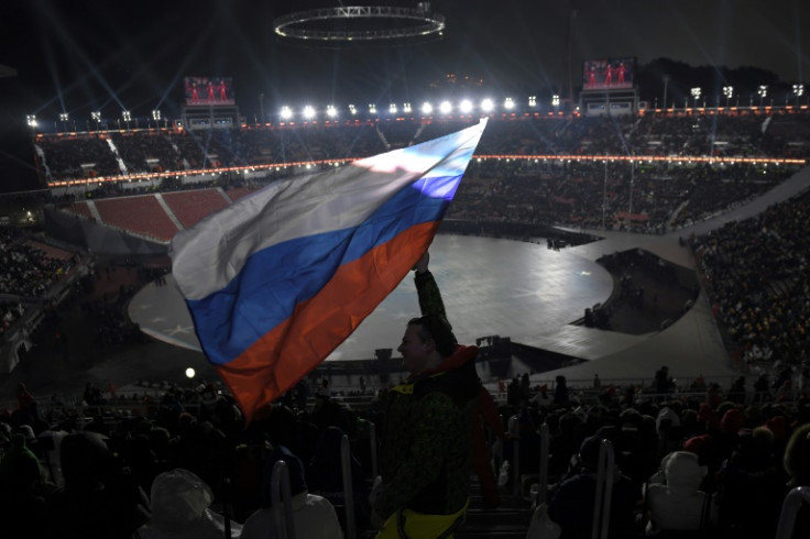 A spectator waves the Russian flag ahead of the opening ceremony of the 2018 Pyeongchang Winter Olympics
