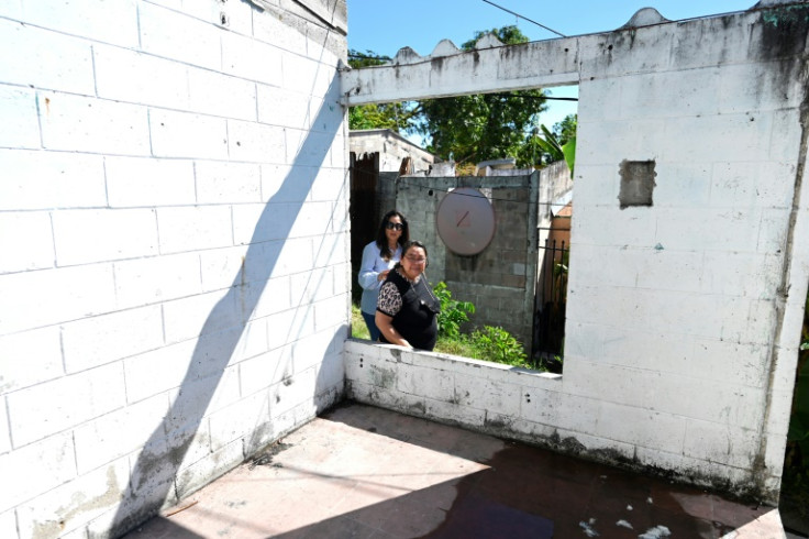 El Salvador's housing minister, Michelle Sol (L), has helped people like Ana Cuellar (R) recover their homes -- after years of gang occupation