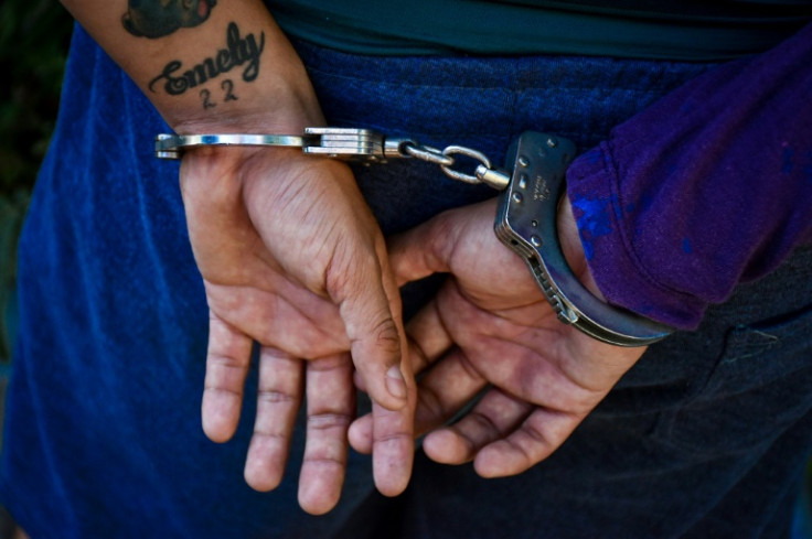 A suspect being detained in El Salvador's Soyapango municipality in December 2022 during nationwide sweeps on gangs