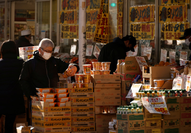 Shoppers check foods at a supermarket in Tokyo