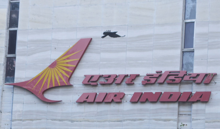 A bird flies over a logo of Air India airlines at the corporate headquarters in Mumbai