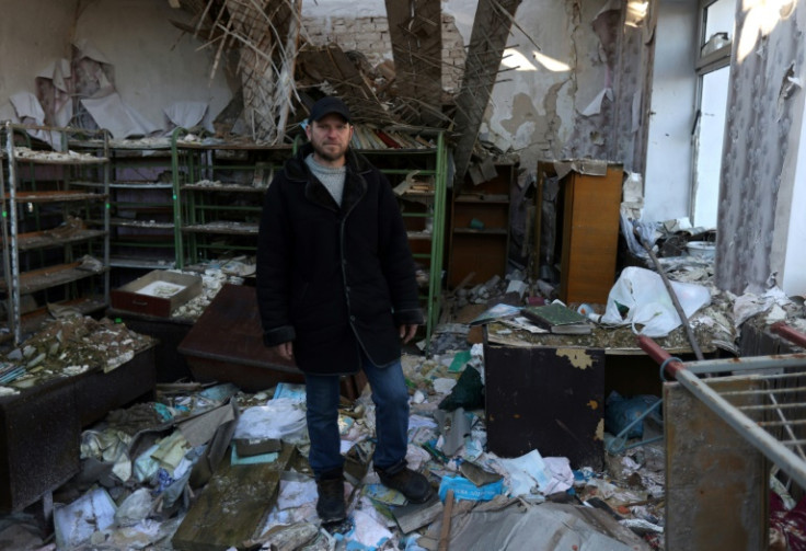 Ukrainian teacher Oleksandr Pogoryelov, 45, stands in his former school