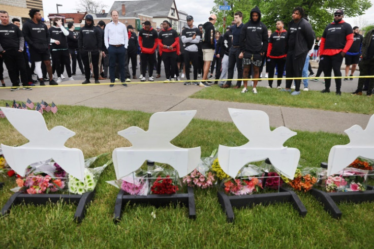 Members of the Buffalo Bills lay flowers at a memorial near where 10 people were killed in May 2022 in Buffalo